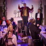 Ensemble of actors at dinner party