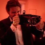 Actor holding vintage camera