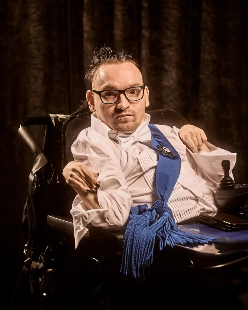 Actor in wheelchair dressed in 1920's clothing