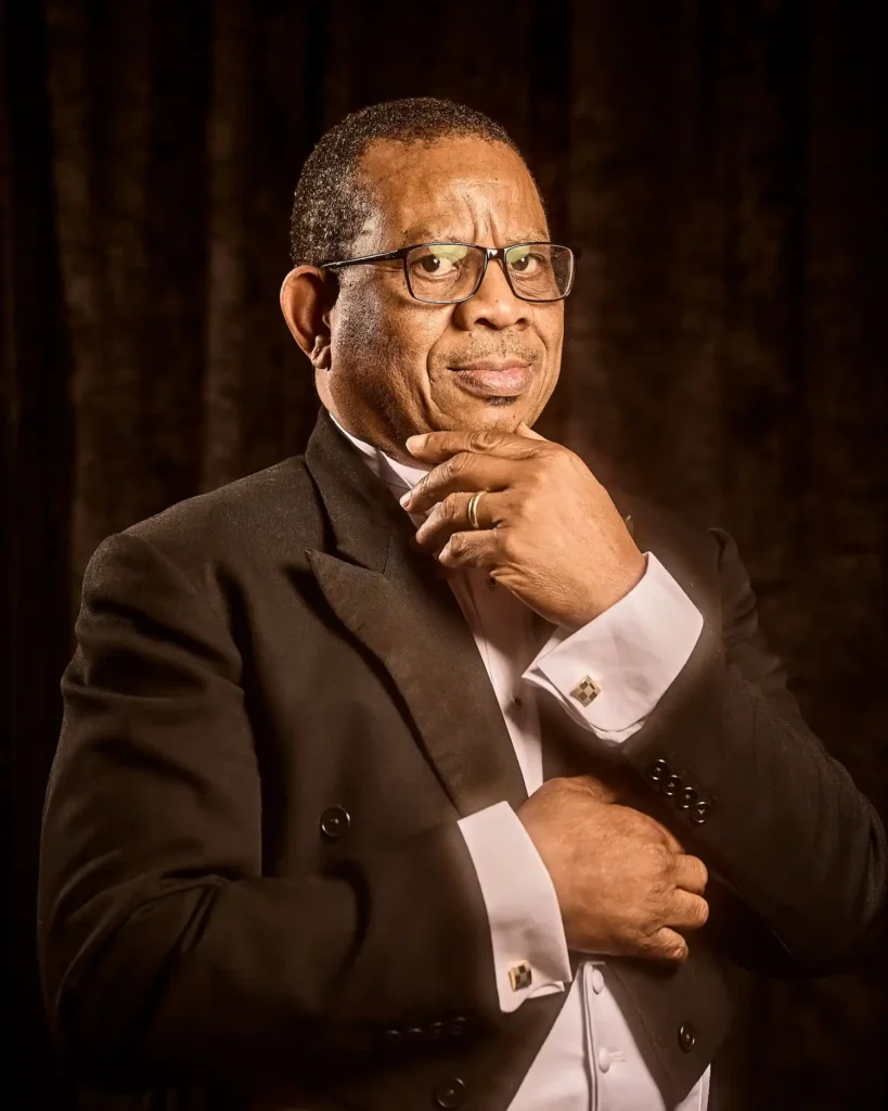 Actor dressed holding hand to chin