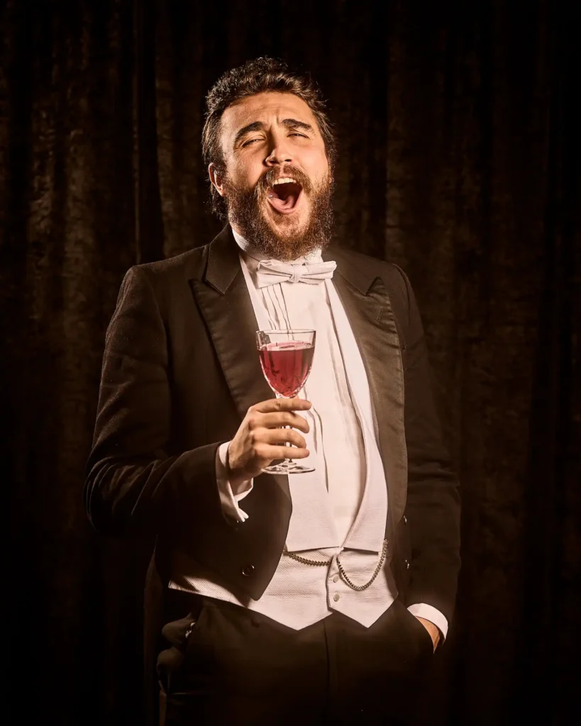 Potrait of actor laughing with glass in hand