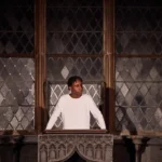 Actor standing behind alter