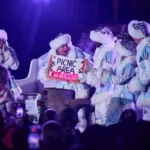5 Actors gathered together, taking sign board