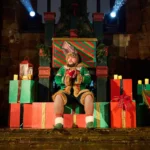 Actor sat on box as elf