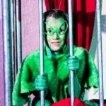 Child actor dressed alien in cage