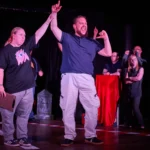 Actress holding up Actor arm