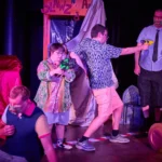 Actor and actress playing with toy guns