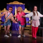 Two actors dressed as women with actress