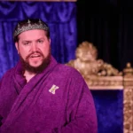 Actor with purple robe and crown