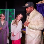 Two actresses fawning for actor