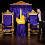 Actor standing next to large inflatable duck