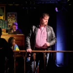 Actor looking over bannister