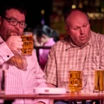 Two actors drinking beer