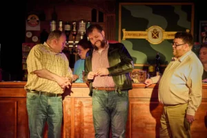 Three actors infront of bar