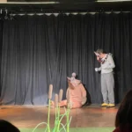 Actors dressed as mouse and wolf