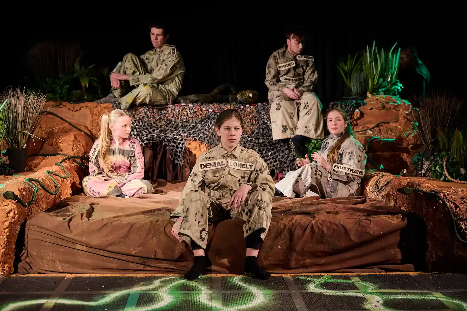 5 actors in on large sofa