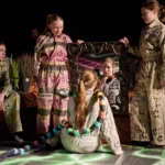 Actor infront of mirror with snake around neck