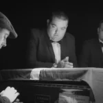 Three actors around piano