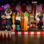 Ensemble of actor dressed as circus performers