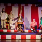 Actress dressed as fortune teller with ensemble