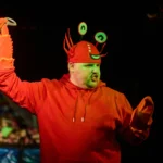 Actor dressed as a crab with a spoon in one hand