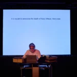 Actress typing infront of projector screen