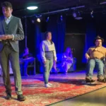 Three actors on stage