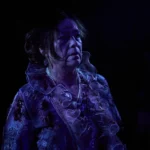 Actress in torn clothing covered in dirt