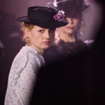 Actress in edwardian clothing looking away