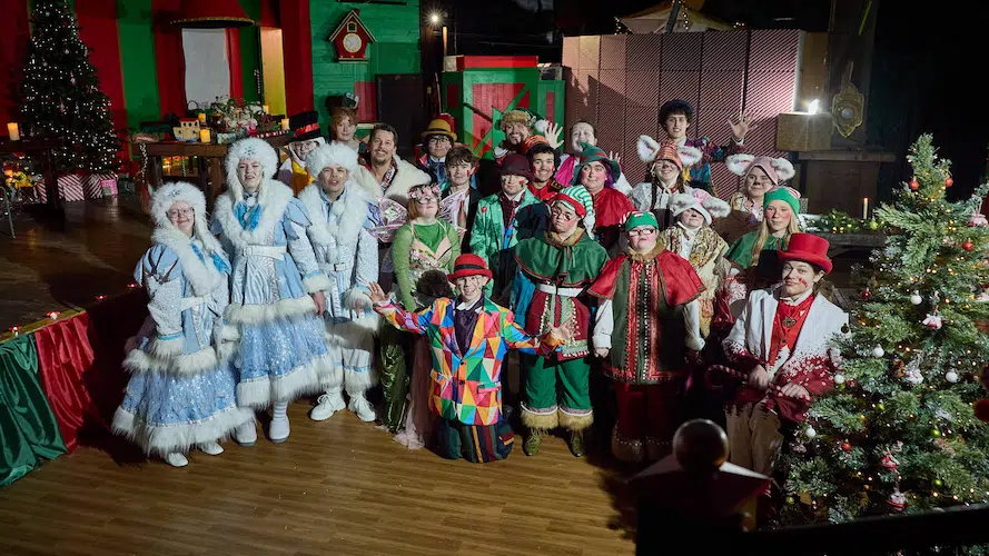 A group of 25 actors dressed as Christmas characters.